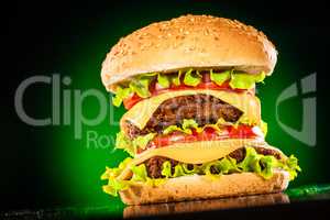 Tasty and appetizing hamburger on a darkly green