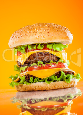 Tasty and appetizing hamburger on a yellow