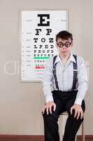 person wearing spectacles in an office at the doctor