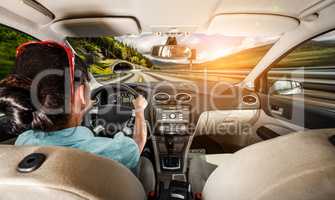 Woman behind the wheel of a car.