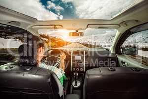 Woman behind the wheel of a car.