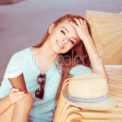 Attractive Woman with Coffee Sitting on the Chair