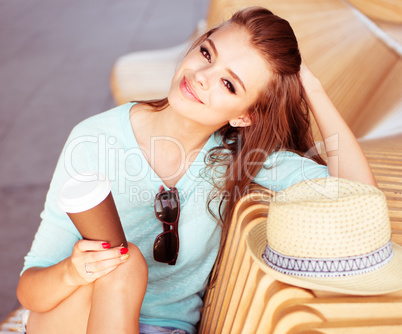 Attractive Woman with Coffee Sitting on the Chair