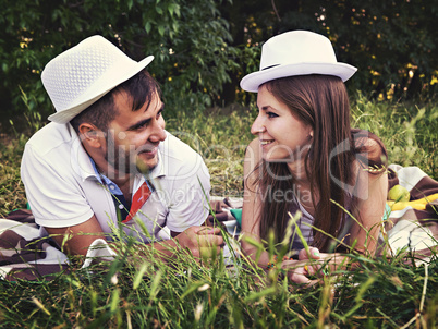 happy young couple relaxing in the park on the grass