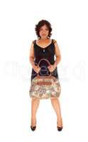 Mixed raced woman holding her purse.
