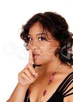 Woman holding finger over her mouth.