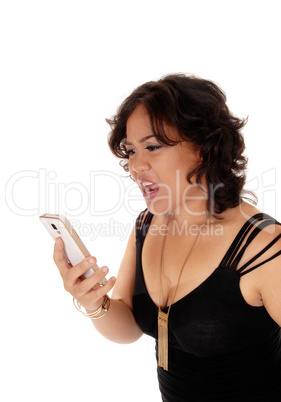 Young woman shouting at her cell phone.