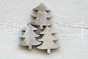 Three Christmas Trees On White Wooden Background