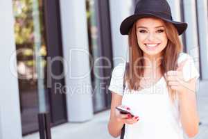 Attractive Girl with Phone Showing Thumbs Up