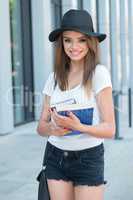 Pretty Female Student Holding her Books