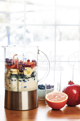 Preparing smoothies with fruit and yogurt