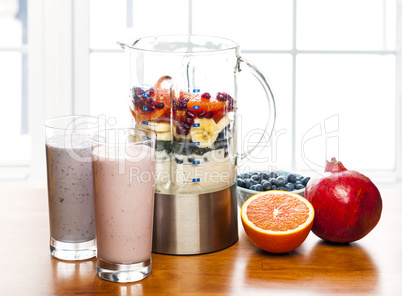 Making smoothies in blender with fruit and yogurt