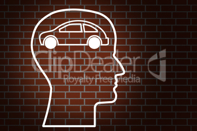 Head by car on brick wall