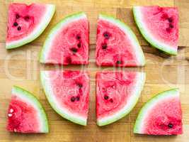 Watermelon slices arranged in a circle shape and around