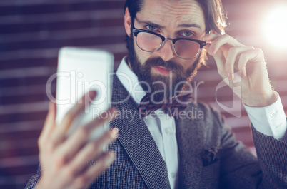 Portrait of fashionable man taking picture of himself
