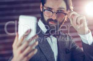Portrait of fashionable man taking picture of himself