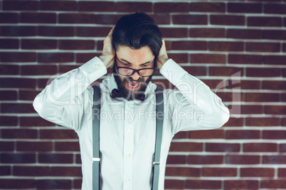 Portrait of frustrated man covering ears