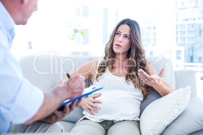 Preganant woman taking advice of therapist