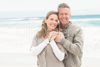 Smiling couple holding one another