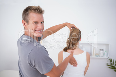 Doctor examining his patient back Doctor examining his patient back