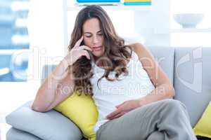 Pregnant woman sitting in living room