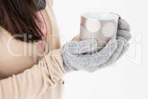 Woman holding polka dotted mug
