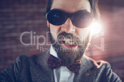 Portrait of angry fashionable man wearing sunglasses