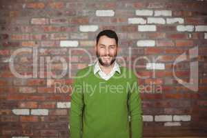 Portrait of happy businessman standing against wall