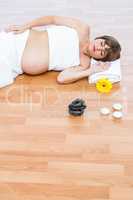 Pregnant woman resting on hardwood floor