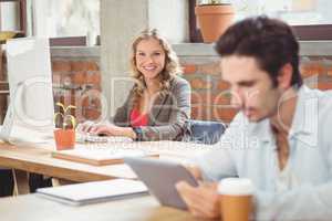 Portrait of young businesswoman working on computer