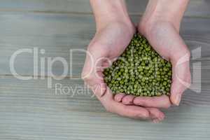 Woman showing handful of lentils