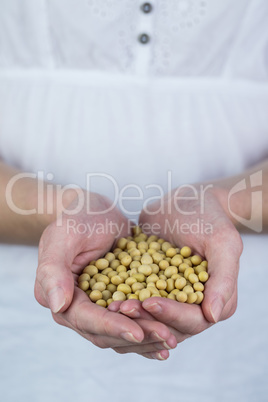 Woman showing handful of chickpeas