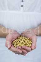 Woman showing handful of chickpeas