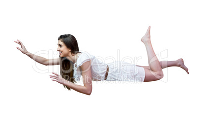 Girl in white dress floating in air