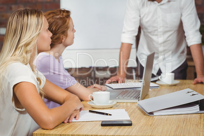 Businesswoman looking at male colleague