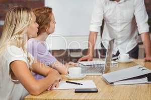 Businesswoman looking at male colleague