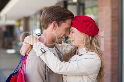 A smiling happy woman hugging her boyfriend