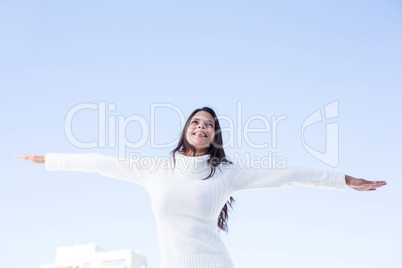 Pretty brunette feeling the air with arms raised up