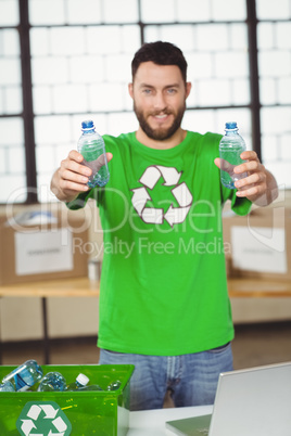 Man holding bottles while standing in office