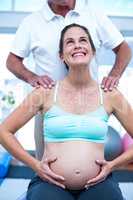 Pregnant woman looking up in gym