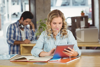 Beautiful businesswoman using table in office