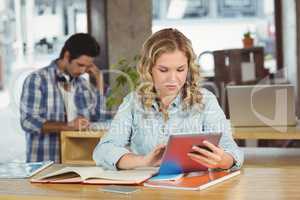 Beautiful businesswoman using table in office