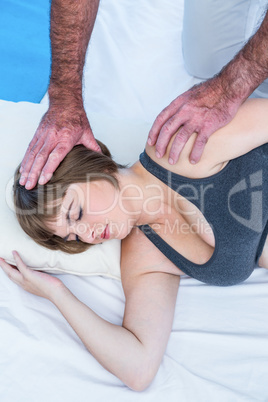 High angle view of therapist giving  treatment to woman