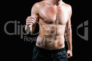 Midsection of shirtless athlete running