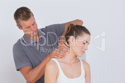 Doctor examining his patient neck