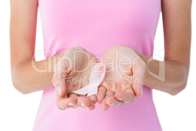 Woman holding pink ribbon for breast cancer awareness