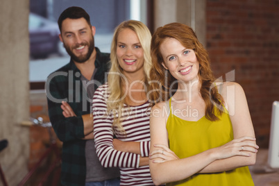 Confident business people standing arms crossed