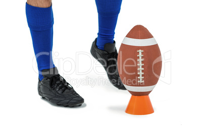 American football player about to kick ball