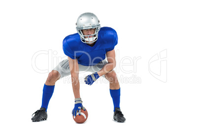 Alert American football player in attack stance
