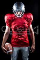 American football player standing with ball